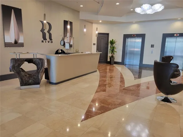 a living room with furniture a mirror and lamp