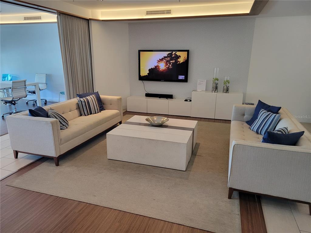 1771 Ringling Boulevard, Unit 902 Sarasota, FL 34236 - Photo 46 of 60 a living room with furniture and a flat screen tv