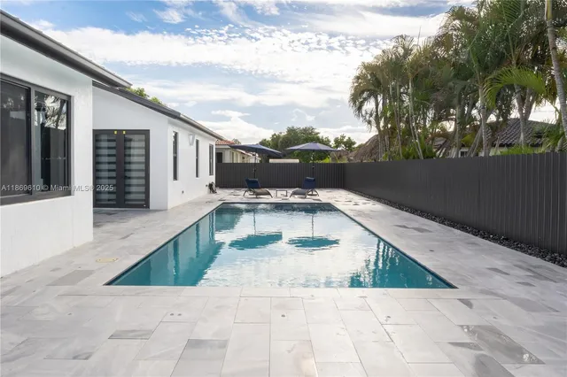a swimming pool with outdoor seating and yard