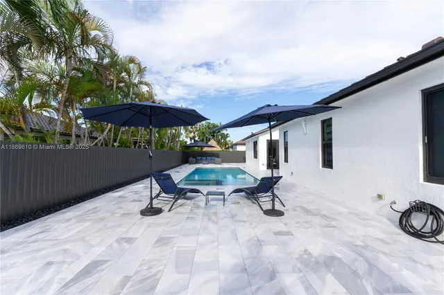 a view of a backyard with sitting area and furniture