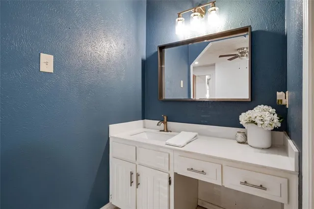 a bathroom with a sink a mirror and vanity