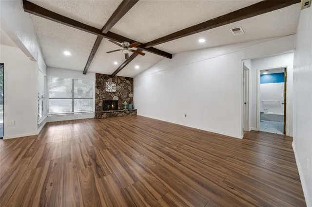 a view of a room with wooden floors