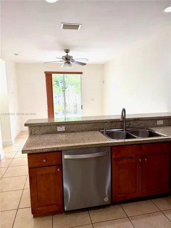 a kitchen with granite countertop a sink and a stove