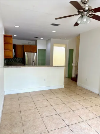 a view of a kitchen with a sink and cabinets