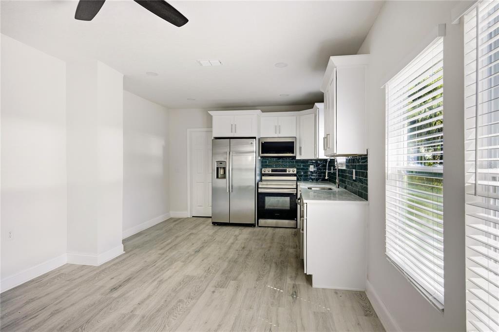 418 Northwest 3rd Avenue Gainesville, FL 32601 - Photo 12 of 31 a kitchen with stainless steel appliances a refrigerator and a stove top oven