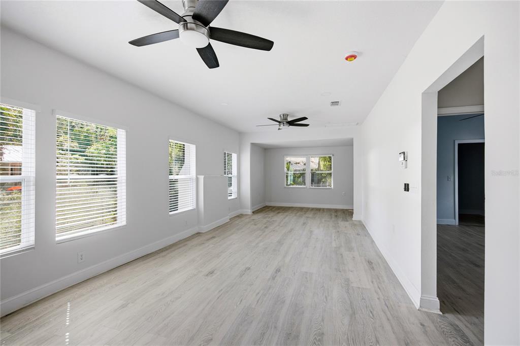 418 Northwest 3rd Avenue Gainesville, FL 32601 - Photo 13 of 31 a view of an empty room with a window and wooden floor