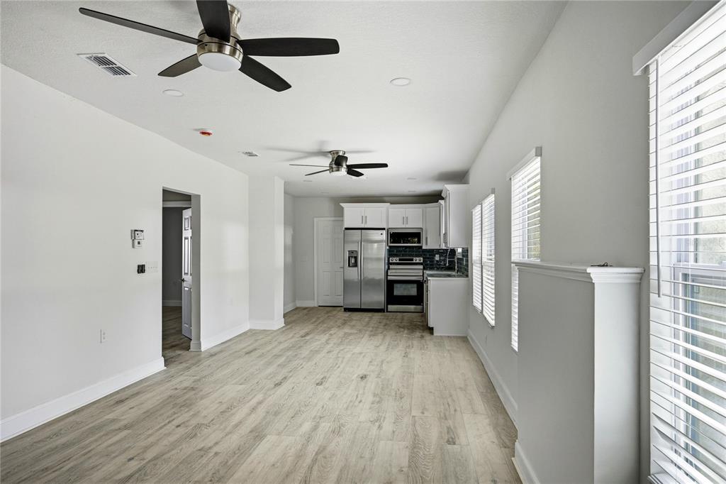 418 Northwest 3rd Avenue Gainesville, FL 32601 - Photo 14 of 31 a kitchen with stainless steel appliances a refrigerator and a stove top oven