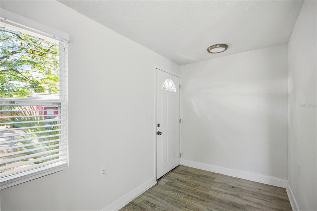 418 Northwest 3rd Avenue Gainesville, FL 32601 - Photo 20 of 31 a view of an empty room with wooden floor and a window