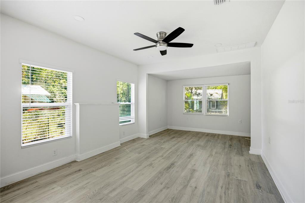 418 Northwest 3rd Avenue Gainesville, FL 32601 - Photo 21 of 31 a view of an empty room with a window and wooden floor
