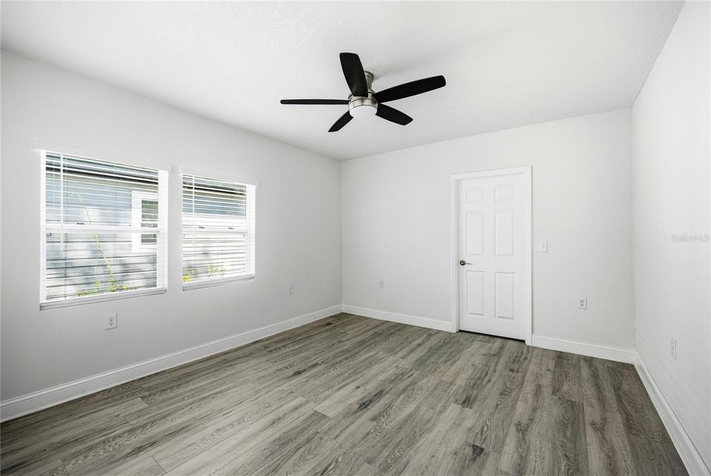 418 Northwest 3rd Avenue Gainesville, FL 32601 - Photo 22 of 31 a view of empty room with wooden floor and fan