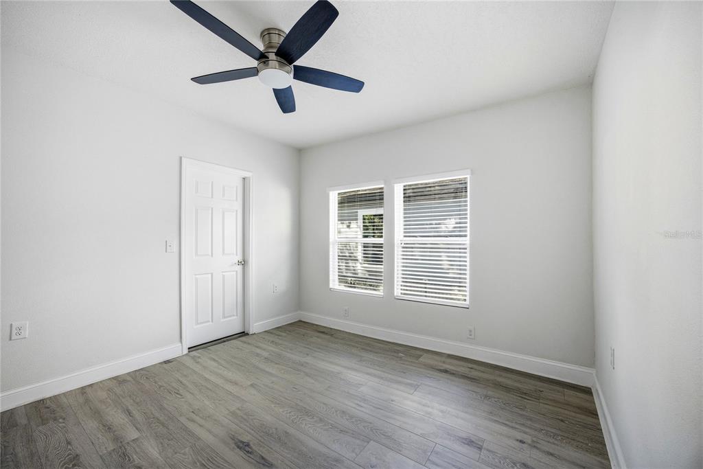 418 Northwest 3rd Avenue Gainesville, FL 32601 - Photo 23 of 31 an empty room with wooden floor and windows
