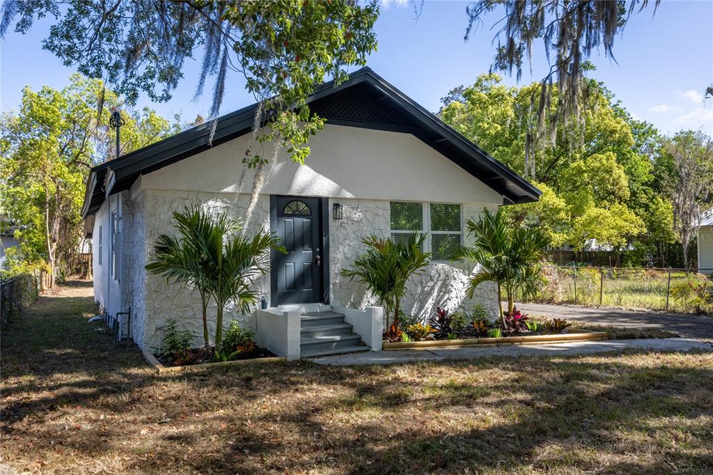 418 Northwest 3rd Avenue Gainesville, FL 32601 - Photo 7 of 31 a view of a house with small yard plants and palm trees