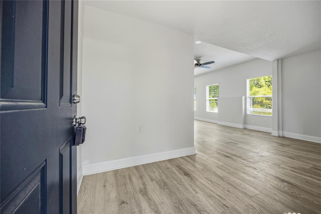 418 Northwest 3rd Avenue Gainesville, FL 32601 - Photo 10 of 31 wooden floor in an empty room with a window