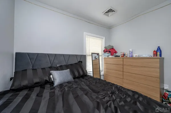 a bedroom with a bed and cabinet