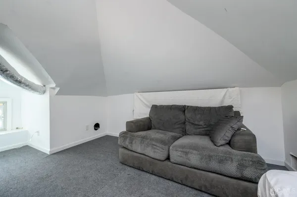 a living room with furniture and white walls