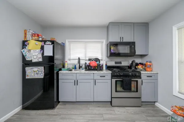 a kitchen with stainless steel appliances granite countertop a stove top oven a sink and dishwasher