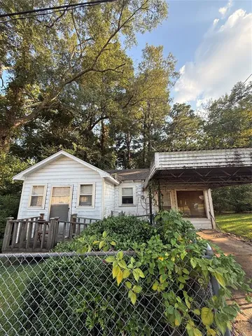 a front view of a house with a yard garage and outdoor seating
