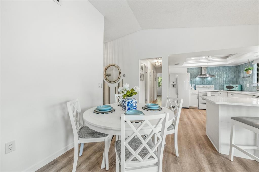 2911 Woodpine Court Sarasota, FL 34231 - Photo 16 of 88 a view of a dining room with furniture and wooden floor