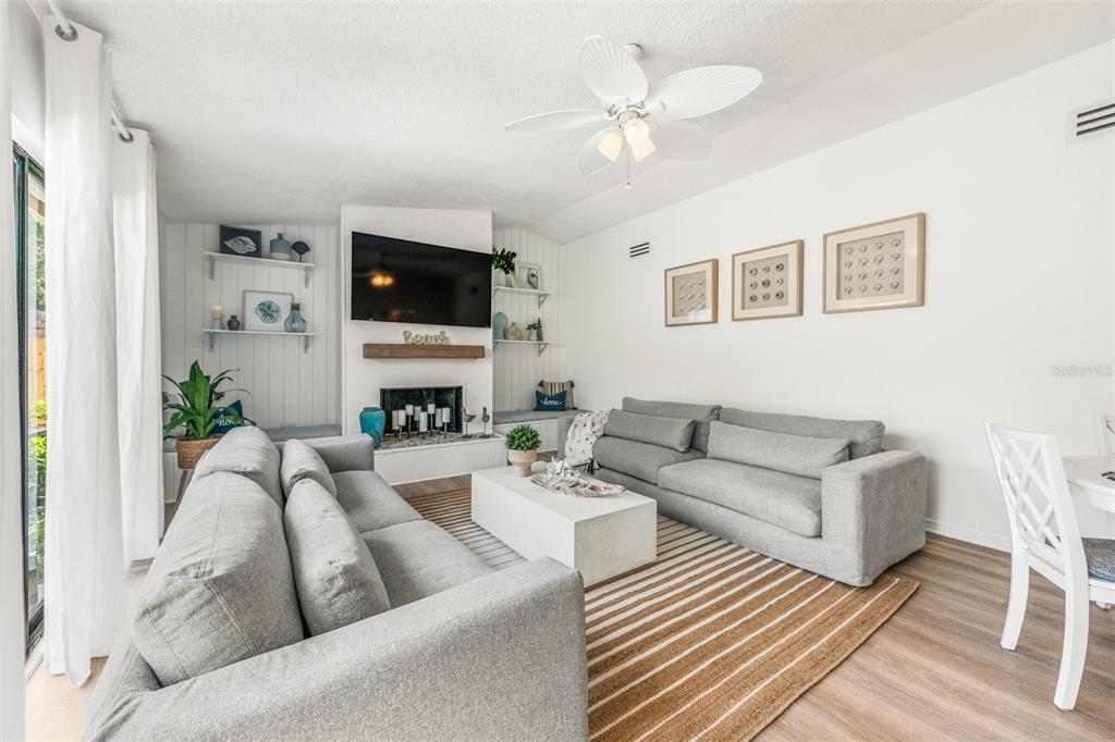 2911 Woodpine Court Sarasota, FL 34231 - Photo 19 of 88 a living room with furniture a flat screen tv and a fireplace