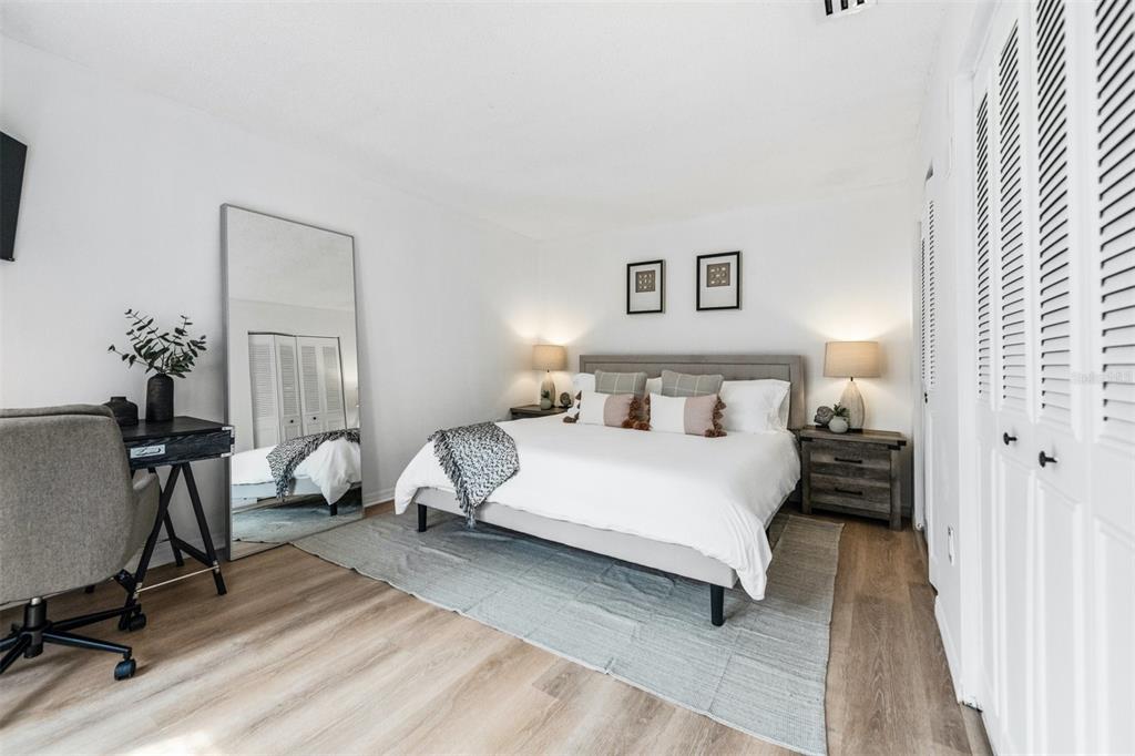 2911 Woodpine Court Sarasota, FL 34231 - Photo 23 of 88 a bedroom with a bed and a chair