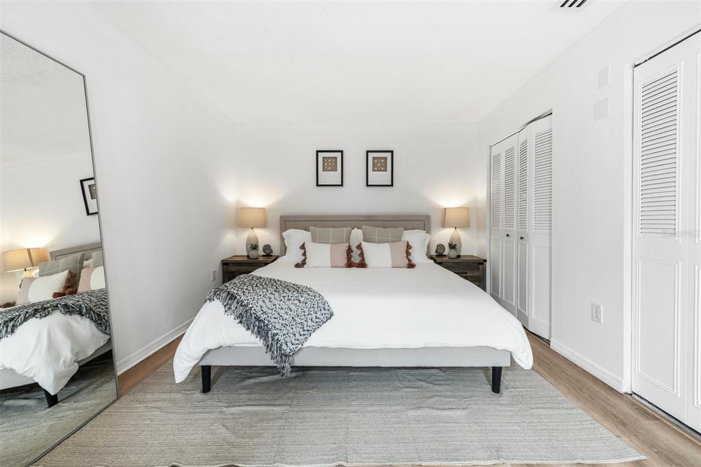 2911 Woodpine Court Sarasota, FL 34231 - Photo 24 of 88 a bedroom with a large bed and a couch