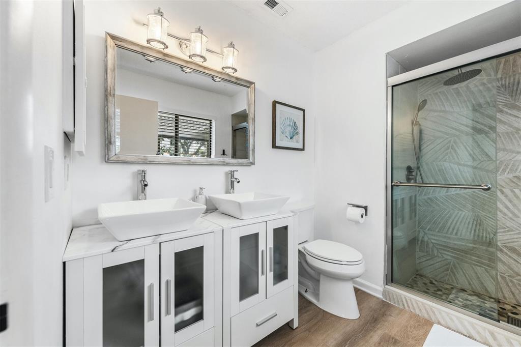 2911 Woodpine Court Sarasota, FL 34231 - Photo 27 of 88 a bathroom with a sink toilet and shower