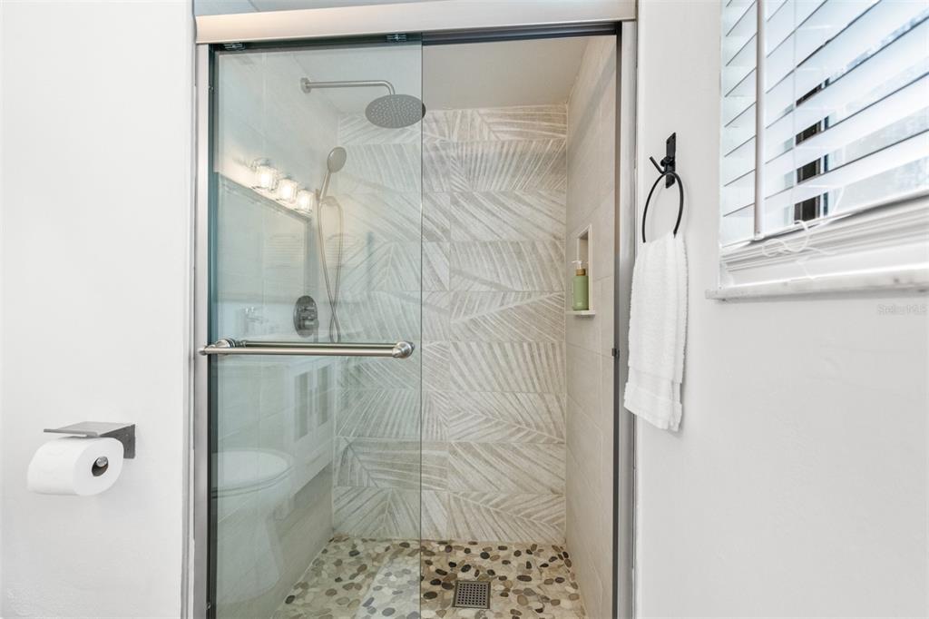 2911 Woodpine Court Sarasota, FL 34231 - Photo 28 of 88 a bathroom with a glass shower door