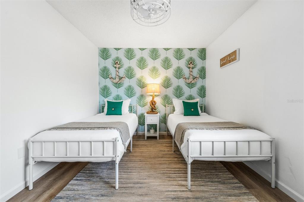 2911 Woodpine Court Sarasota, FL 34231 - Photo 31 of 88 a bedroom with two beds and a table