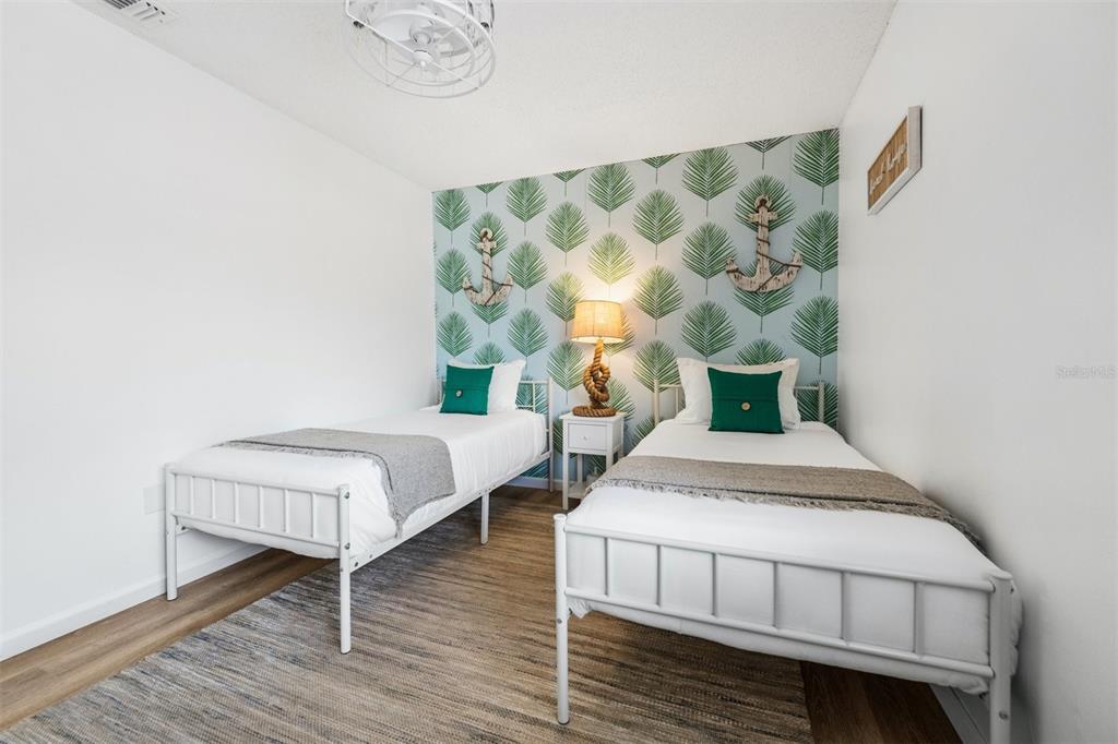 2911 Woodpine Court Sarasota, FL 34231 - Photo 32 of 88 a bedroom with furniture and a wooden floor