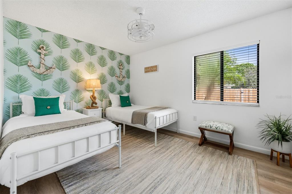 2911 Woodpine Court Sarasota, FL 34231 - Photo 33 of 88 a bedroom with a bed and a window