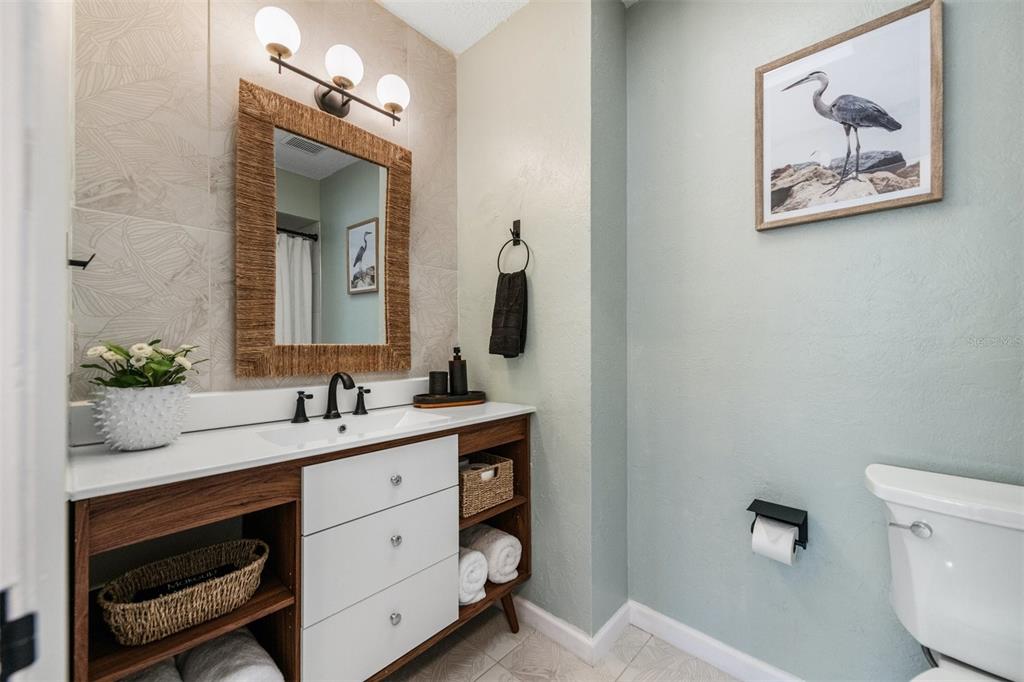 2911 Woodpine Court Sarasota, FL 34231 - Photo 35 of 88 a bathroom with a toilet sink and mirror