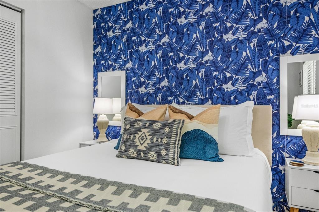 2911 Woodpine Court Sarasota, FL 34231 - Photo 39 of 88 a bedroom with a bed and a night stand