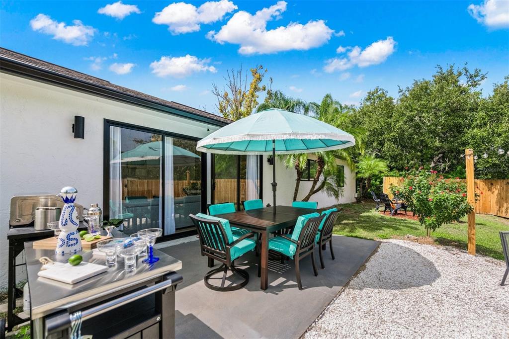 2911 Woodpine Court Sarasota, FL 34231 - Photo 42 of 88 a view of a patio with furniture and a garden