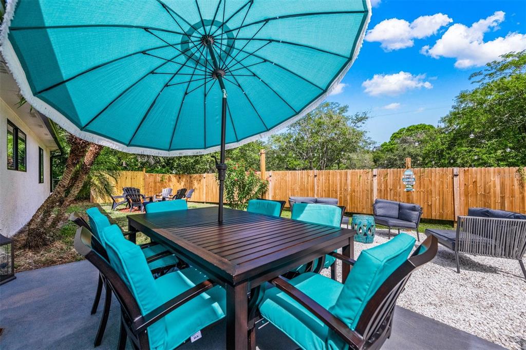 2911 Woodpine Court Sarasota, FL 34231 - Photo 47 of 88 an outdoor space with furniture and umbrella