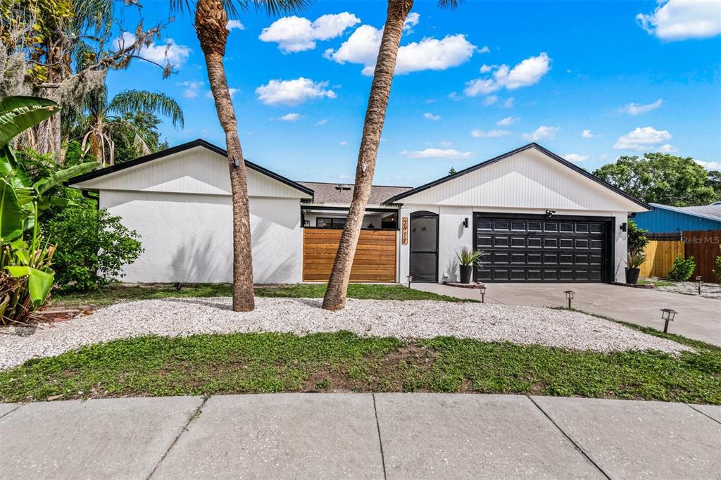 2911 Woodpine Court Sarasota, FL 34231 - Photo 52 of 88 a front view of a house with garden