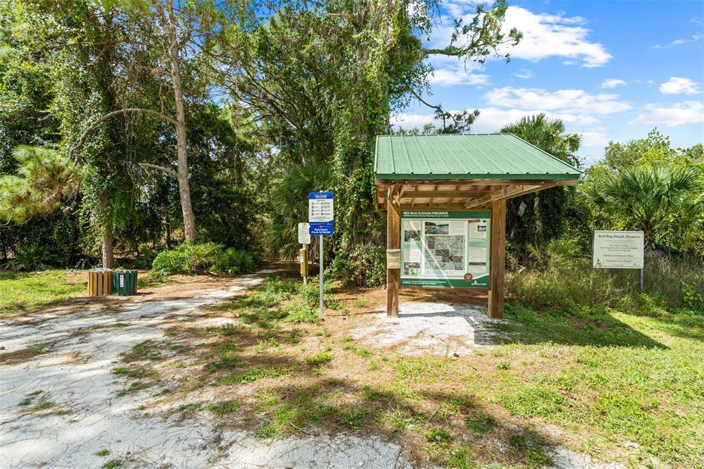 2911 Woodpine Court Sarasota, FL 34231 - Photo 58 of 88 a view of a house with a backyard and a tree