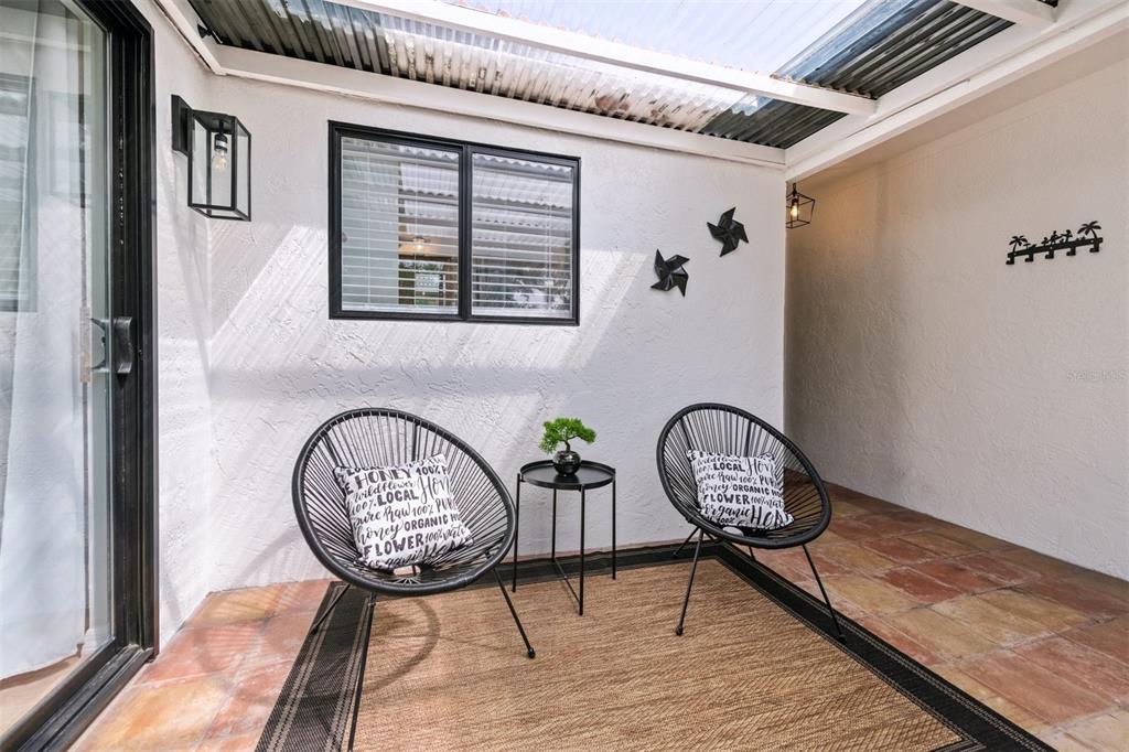 2911 Woodpine Court Sarasota, FL 34231 - Photo 6 of 88 a view of a hallway with wooden floor and a potted plant