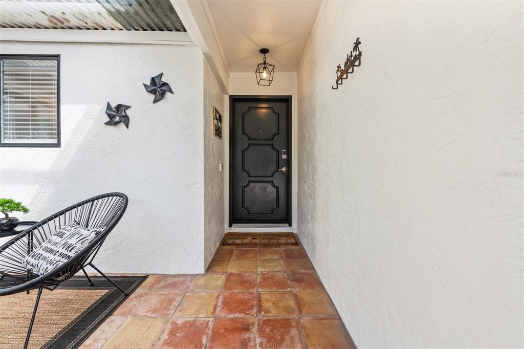 2911 Woodpine Court Sarasota, FL 34231 - Photo 7 of 88 a view of a hallway with wooden floor and a potted plant