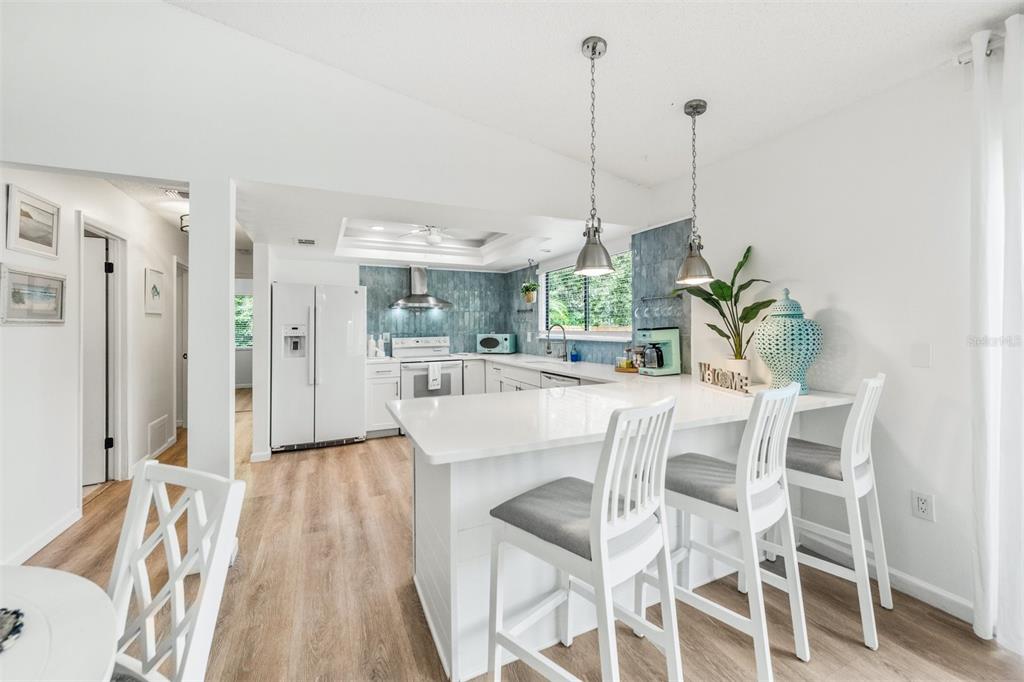 2911 Woodpine Court Sarasota, FL 34231 - Photo 10 of 88 a view of a dining room with furniture wooden floor and a chandelier