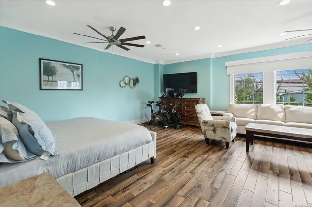 a spacious bedroom with a bed couch and a window