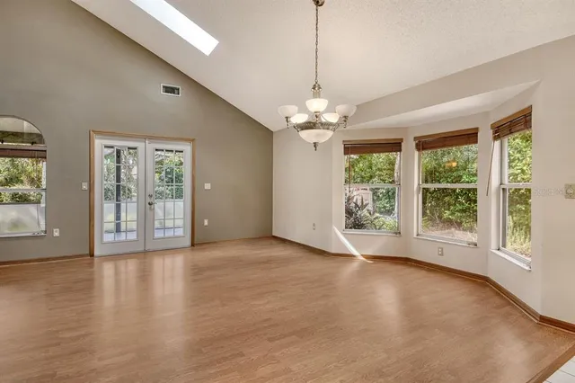 a view of a big room with wooden floor and a ceiling fan