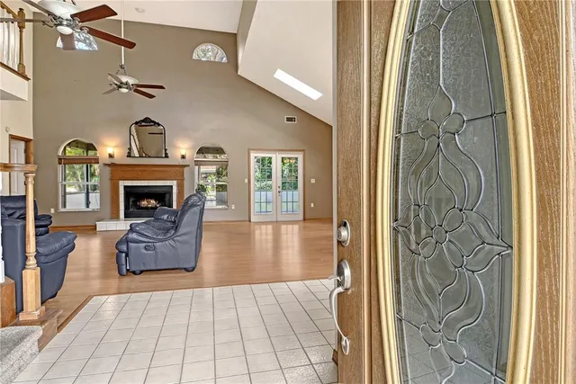 a living room with furniture a fireplace and a chandelier