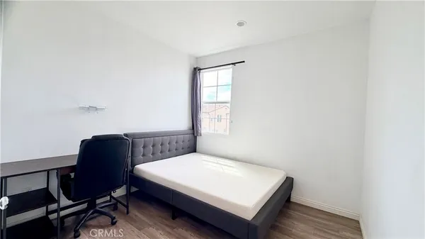 a bedroom with a bed and chair