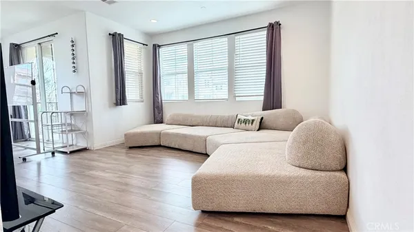 a bedroom with furniture and a large window