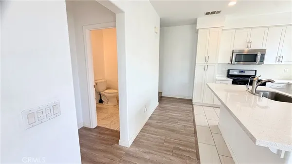 a kitchen with stainless steel appliances a refrigerator and a stove top oven