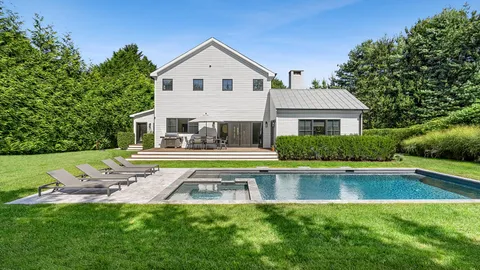 a front view of house with yard and outdoor seating