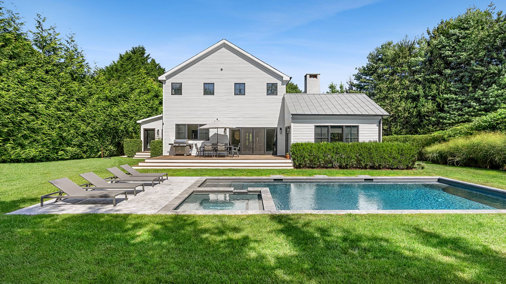 a front view of house with yard and outdoor seating