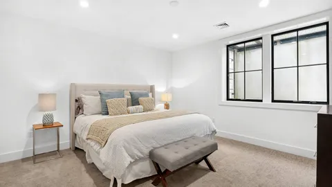 a bedroom with a bed and a large window