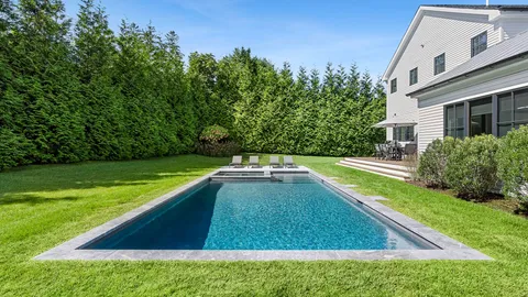 a view of a backyard with swimming pool