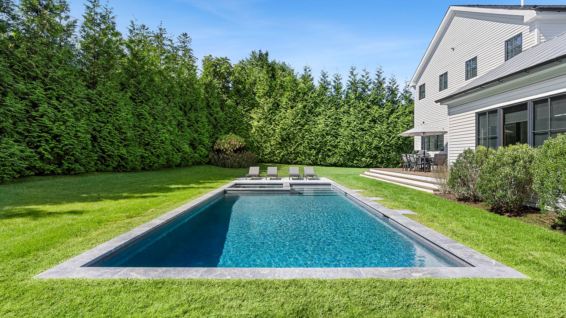 6 Inkberry Street East Hampton, NY 11937 - Photo 17 of 18 a view of a backyard with swimming pool